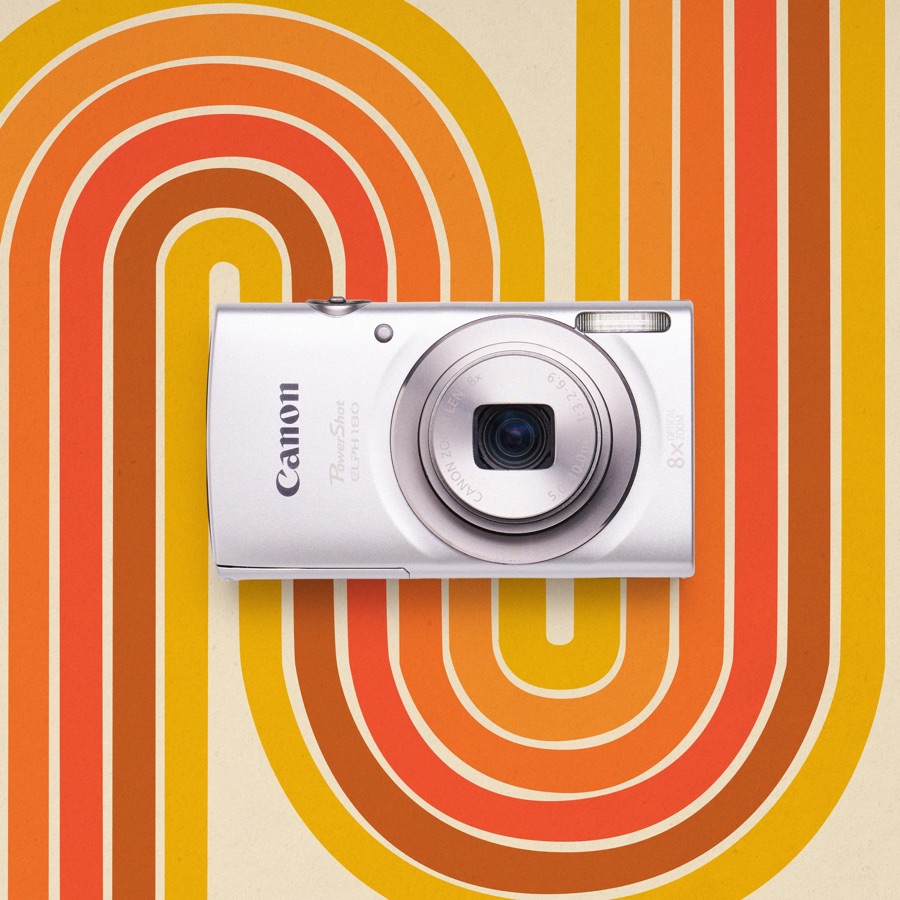 A silver Canon PowerShot ELPH 180 on an orange graphic background