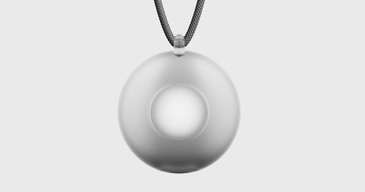 The circular Friend AI pendant on its cord