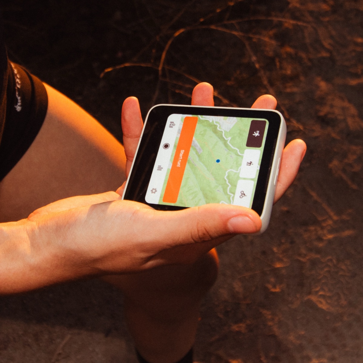 The compact Meadow phone showing a trail map in a person's hand